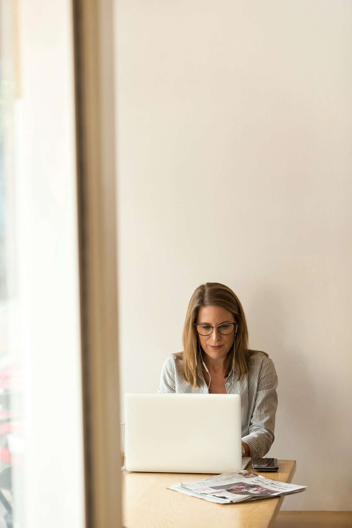 Property manager reviewing strata reports on a laptop