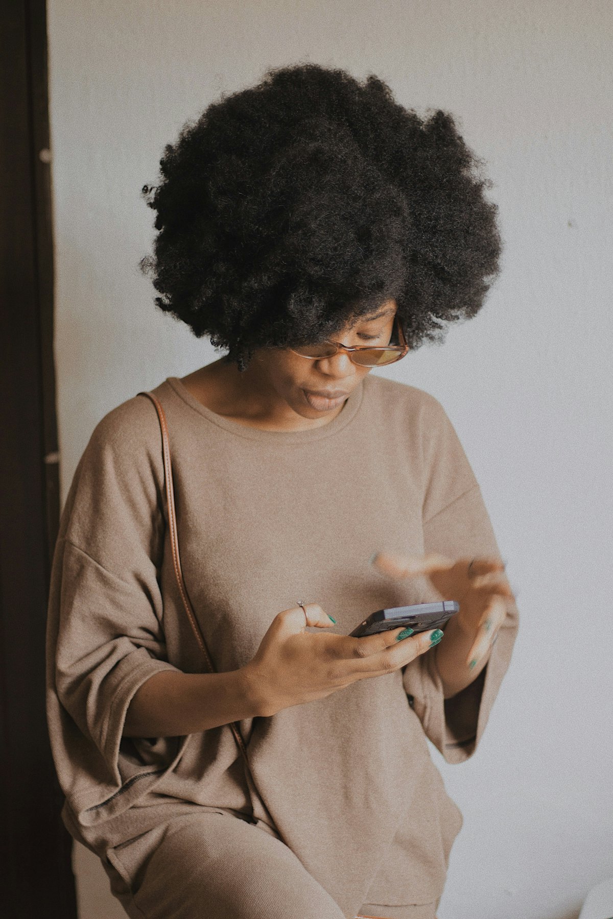Caribbean resident checking their strata balance on a phone